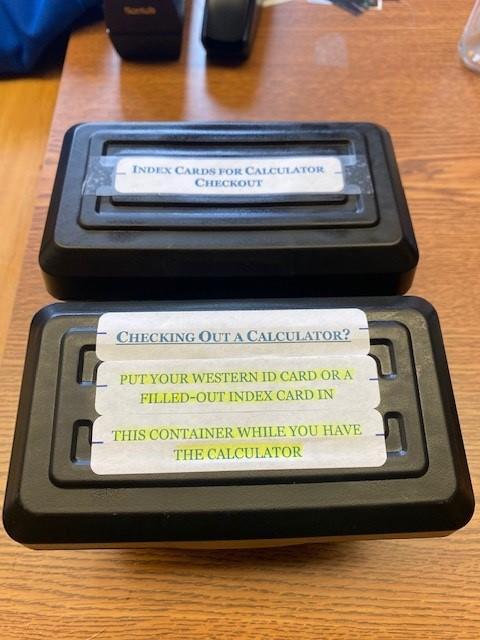 Two boxes for calc rental procedure.  One holds ID cards or contact cards while calculator is rented.  The other holds blank contact cards and stored contact cards.